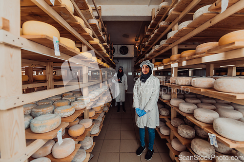 Image of Arab business partner visiting a cheese factory. The concept of investing in small businesses