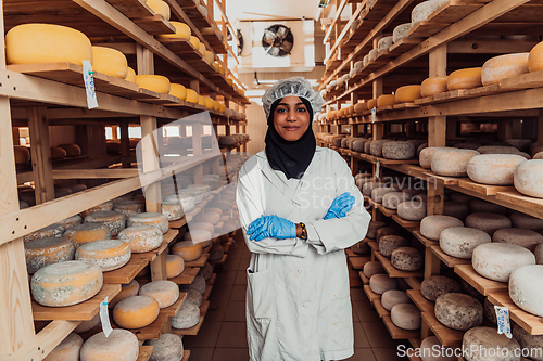 Image of Arab investor in a warehouse of the cheese production industry