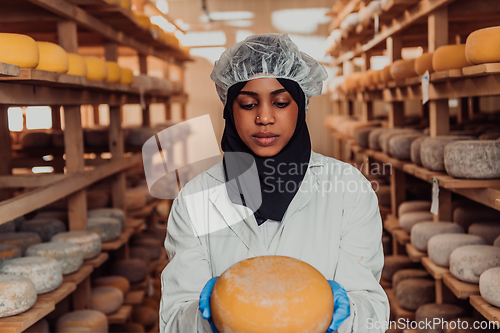 Image of Arab investor in a warehouse of the cheese production industry