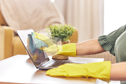Image of Cleaning, laptop and hands of woman in home with rubber gloves for hygiene, disinfection and washing. Cleaner service, housekeeping and closeup of female maid wipe dust, dirt and stain on computer