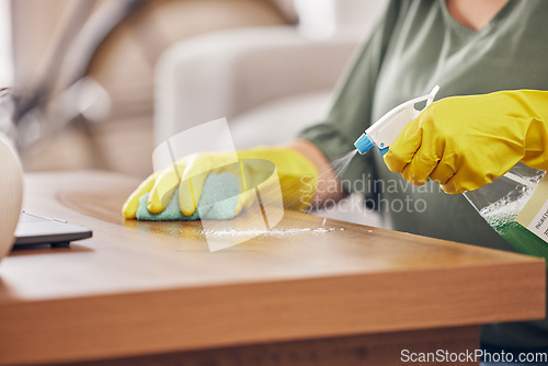 Image of Hands, gloves and cleaning service a table in a home with safety from germs or dirt. Cleaner, dust and rubber protection with spray for household maintenance with a woman in a clean apartment