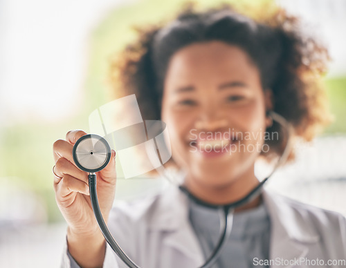 Image of Healthcare, stethoscope and cardiology with a doctor in the hospital for a routine checkup during an appointment. Medical, hand and heart health with a woman medicine professional in a clinic