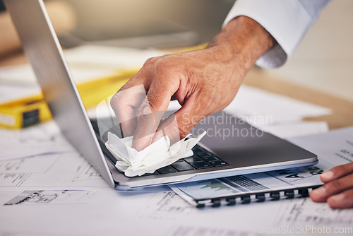 Image of Hand with cloth, keyboard on laptop and cleaning dust or dirt from workspace with blueprint and architecture. Wiping, tissue and engineer with computer cleaner for safety care, caution and paperwork.