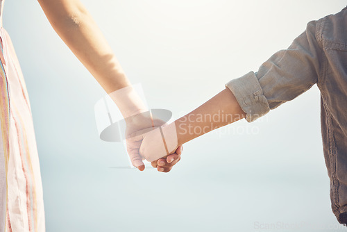 Image of Love, support and holding hands with mother and child for trust, happy and safety on blue sky. Happiness, security and faith with closeup of woman and kid for family, care and kindness together