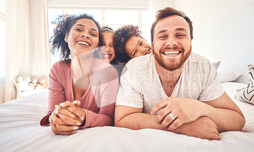 Image of Portrait, happy family and relax on a bed, bond and having fun on the weekend in their home together. Interracial, love and face of playful children with parents in a bedroom, smile and playing games