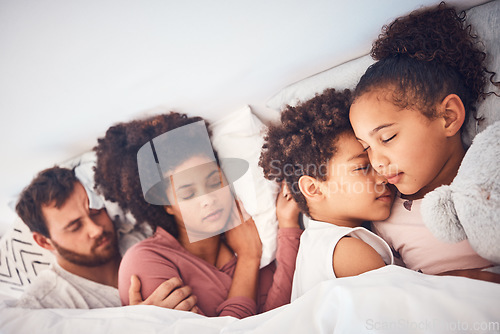 Image of Comfort, sleeping and family in a bed with love, dreaming and resting in their home together. Sleep, nap and children with parents in a bedroom embracing, peaceful and hugging, comfortable and bond