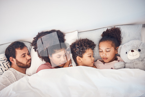 Image of Sleeping, above and family in a bed with love, dreaming and resting in their home cosy together. Sleep, top view and children with parents in a bedroom nap, peaceful and hugging, comfort and bond