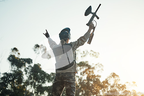 Image of Paintball game, victory and woman celebration, cheers or excited for battlefield success, army training event or achievement. Fun mission winner, nature sky and back of person with competition win