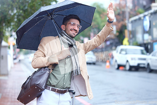 Image of Happy man, umbrella and taxi in city for travel, lift or pick up and waiting on sidewalk of road in rain. Male person waving hand for signal, trip or ride service by street in winter of an urban town