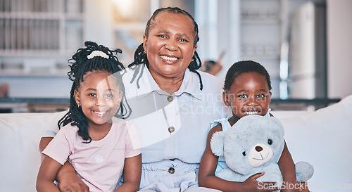 Image of Portrait, black children and senior grandmother on sofa with happiness or quality time with care. Love, kid and happy face with elderly female in family home with smile on couch for bond in lounge.