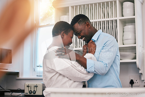 Image of Hug, happy and a mature black couple in the kitchen with care, love and quality time in the morning. Happy, together and an African man and woman with gratitude or kindness in a house for romance