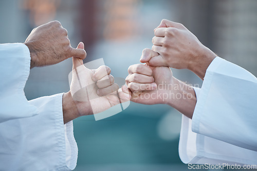 Image of Hands, karate and grip with sports people fighting outdoor in a competition, battle or combat. Fitness, self defense and thumb war with athletes wrestling while training for martial arts together