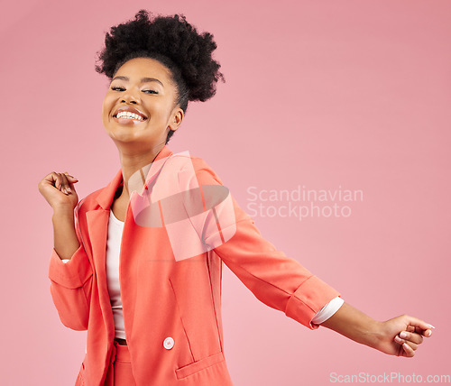 Image of Happy, dance and portrait of a woman in a studio with music, playlist or album for celebration. Happiness, smile and young African female model moving to a song isolated by a pink background.