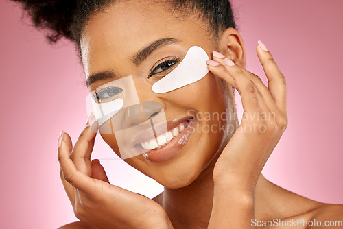 Image of Woman, smile and eye patch for skincare in studio portrait with beauty, cosmetics or product by pink background. Girl, model and facial self care with hands, natural skin glow or aesthetic for health