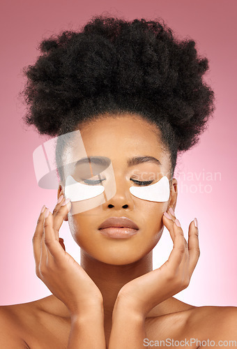 Image of Skin, eye patch or face mask of a woman for dermatology, wellness and skincare glow. Collagen, detox and cosmetics of a black female model with a spa facial for self care on a pink studio background