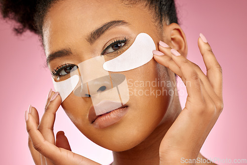Image of Woman, studio and pad for eye, bag and portrait with beauty, cosmetics and product for skin by pink background. Girl, model and facial self care with hands, natural skincare and aesthetic for health
