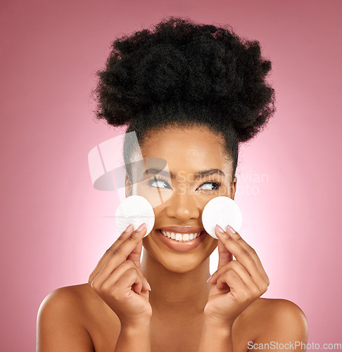 Image of Black woman, cotton pad and skincare with makeup, dermatology and facial on a studio background. Female person, shine and happy model with cosmetics, aesthetic and cleaning with happiness and patches