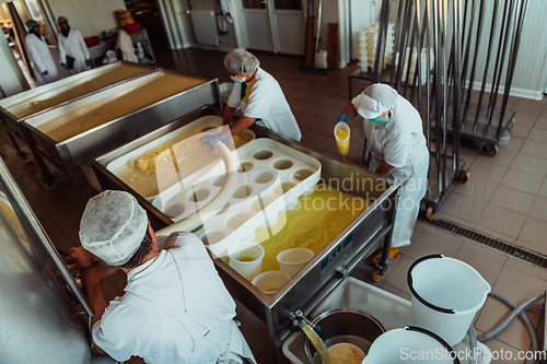 Image of Arab business partners oversee cheese production in modern industry