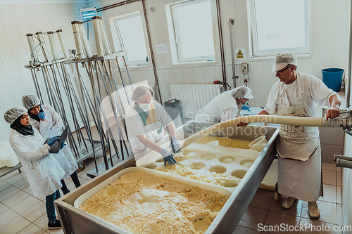 Image of Arab business partners oversee cheese production in modern industry