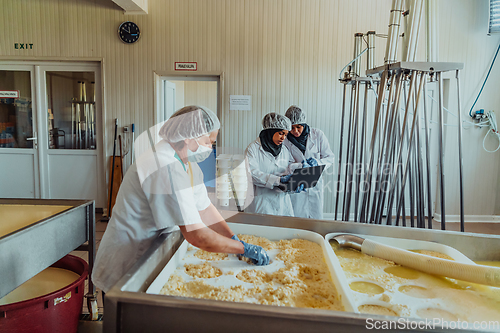 Image of Arab business partners oversee cheese production in modern industry