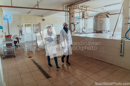 Image of Arab business partner visiting a cheese factory. The concept of investing in small businesses