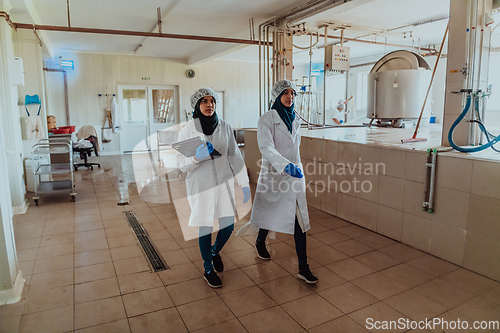 Image of Arab business partner visiting a cheese factory. The concept of investing in small businesses