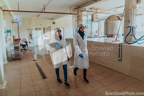 Image of Arab business partner visiting a cheese factory. The concept of investing in small businesses