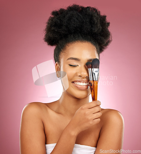 Image of Makeup, smile and black woman with brushes, facial and dermatology against a studio background. Female person, aesthetic and happy model with cosmetic tools, natural beauty and grooming with skincare