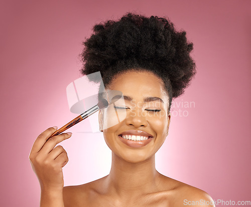 Image of Makeup, smile and black woman with brush, natural beauty and skincare on a studio background. Female person, aesthetic and happy model with cosmetic tools, grooming and dermatology with self care