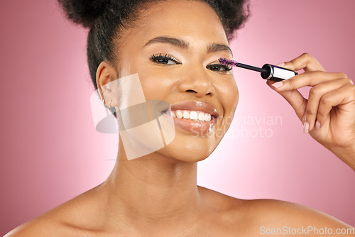 Image of Makeup, mascara and beauty portrait of a woman for skincare, wellness and dermatology glow. Happy, eyelash and face cosmetics of a black female model with facial shine on a pink background in studio