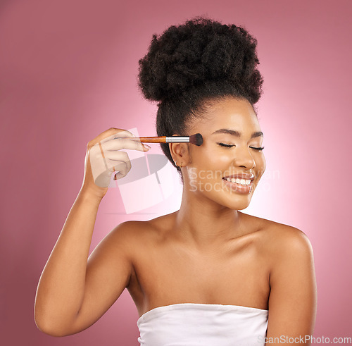 Image of Makeup, smile and black woman with brushes, beauty and dermatology against a pink studio background. Female person, skincare or happy model with cosmetic tools, aesthetic and grooming with self care