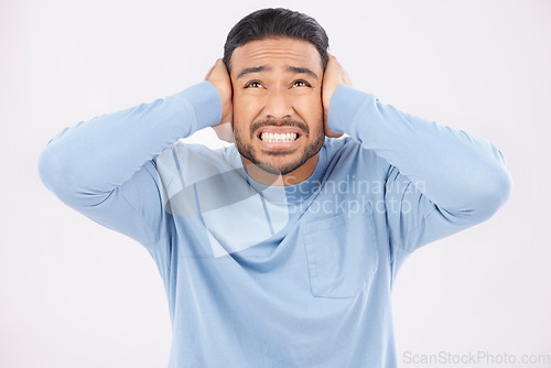 Image of Stress, noise and man with hearing problem in studio isolated on a white background. Tinnitus, frustrated and person with loud sound, crisis and disaster for mental health, anxiety or headache pain