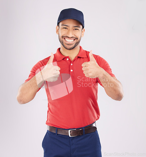Image of Thumbs up, smile and portrait of a happy man in studio with a hand sign for support or thank you. A young asian person on a white background for fashion clothes, like emoji and review or feedback