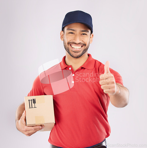 Image of Courier man, thumbs up and studio portrait with box, delivery company and smile by white background. Supply chain manager, happy and review with icon, emoji or sign language with cardboard package