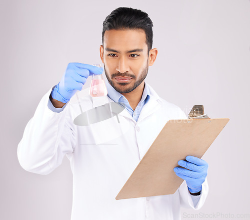 Image of Young scientist man, beaker and checklist with thinking, analysis and notes in studio by white background. Asian science expert, clipboard and paperwork for chemistry, ideas and study at pharma job