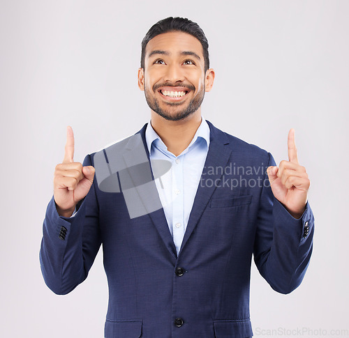 Image of Smile, hand pointing and asian man in studio with sale, announcement or coming soon promo on grey background. Happy, news and Japanese male show launch, platform and giveaway, process or review info