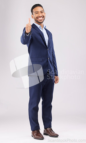 Image of Happy businessman, portrait and thumbs up for approval, success or winning against a white studio background. Asian man smile with like emoji, yes sign or good job for business agreement or thank you