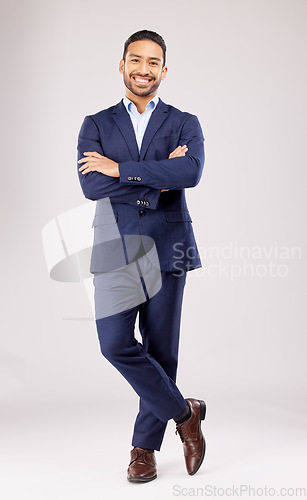 Image of Business man, arms crossed and smile in studio portrait for pride, success or suit by white background. Young asian entrepreneur, happy and excited for finance company, accounting and fashion for job