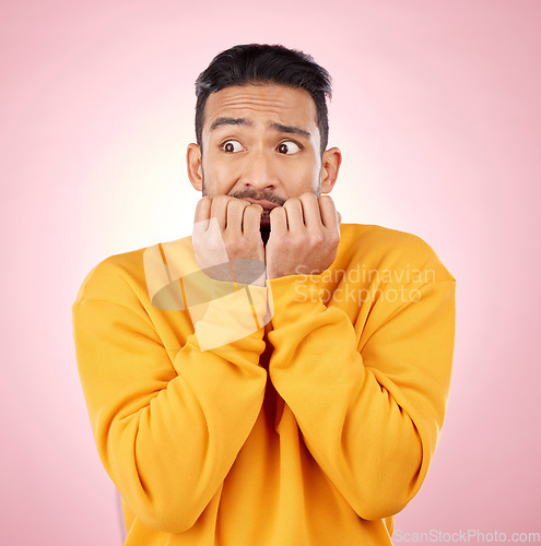 Image of Anxiety, thinking and asian man biting nails in studio with terror, fear and scared for drama on pink background. Stress, gossip and wtf by male person with horror, fake news or worried about secret