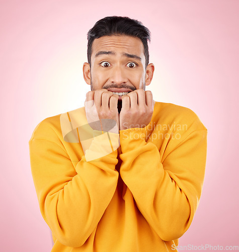 Image of Anxiety, portrait and asian man biting nails in studio with terror, fear and shocking drama on pink background. Stress, gossip and face of male person with horror, fake news or worried about secret