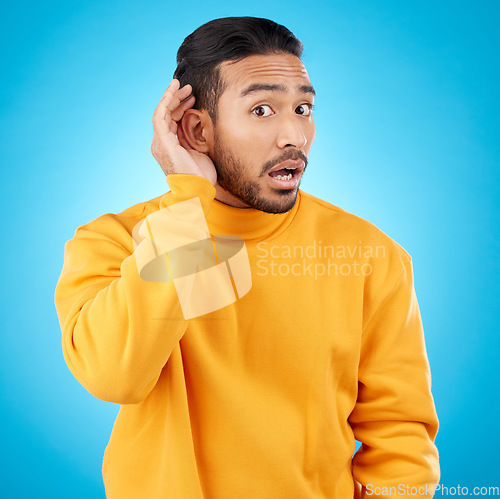 Image of Attention, surprise and asian man with listening to news with asian in studio background for information. Secret, hearing and hand on ear with male person or shocked face in mock up with gossip.