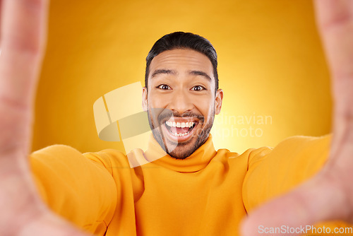 Image of Excited, portrait and selfie of man in studio isolated on a yellow background. Face, smile and Asian person taking profile picture for happy memory, funny or influencer laughing for social media post