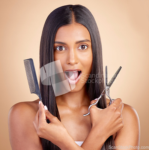 Image of Comb, hair care or portrait of woman with surprise, scissors for self care beauty grooming on studio background. Shocked, wow or Indian girl in salon with tools or cosmetics for haircut treatment