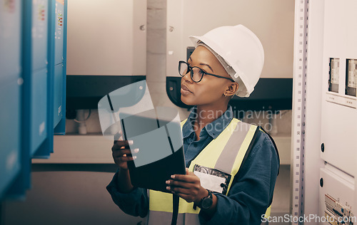 Image of Tablet, construction worker and inspection of electrical box, factory or engineer in industry warehouse for logistics and safety. Black woman, electrician or engineer with generator on power plant