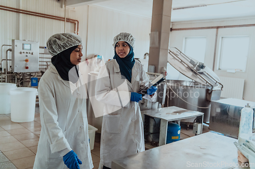 Image of Arab business partner visiting a cheese factory. The concept of investing in small businesses