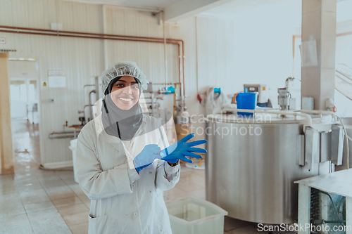 Image of Arab business woman visiting a cheese factory. The concept of investing in small businesses