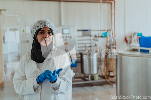 Image of Arab business woman visiting a cheese factory. The concept of investing in small businesses