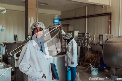 Image of Arab business partner visiting a cheese factory. The concept of investing in small businesses