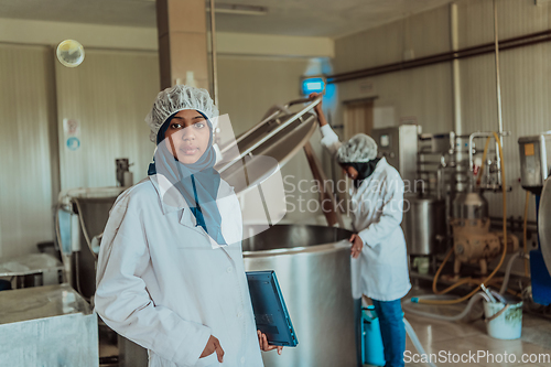 Image of Arab business partner visiting a cheese factory. The concept of investing in small businesses