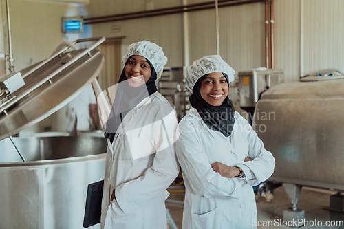 Image of Arab business partner visiting a cheese factory. The concept of investing in small businesses